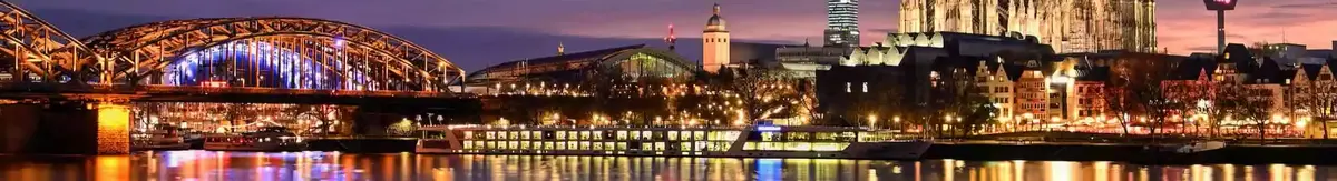 Panorama image of Cologne and its river at night