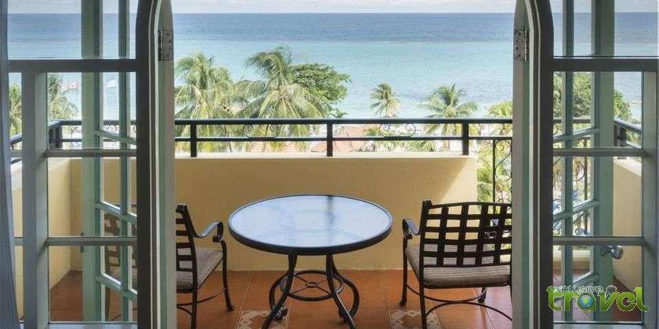 bedroom with ocean view balcony